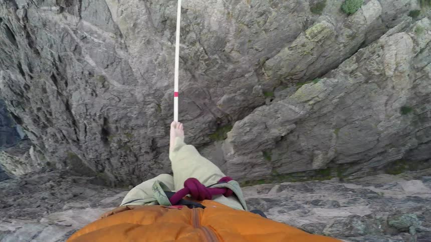 View of a person's feet as they walk over a tightrope