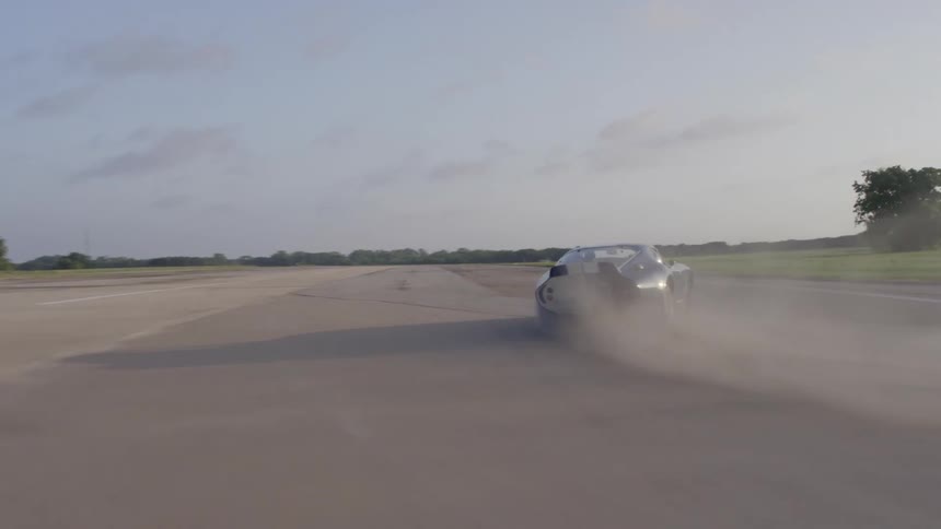 A person racing a car on a track spins out