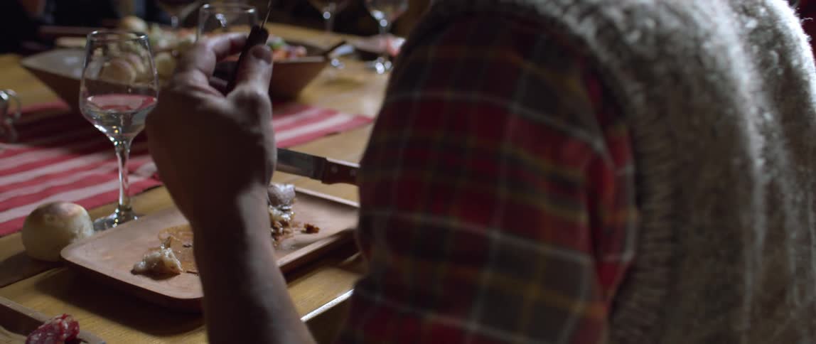 People sit around dinner table eating