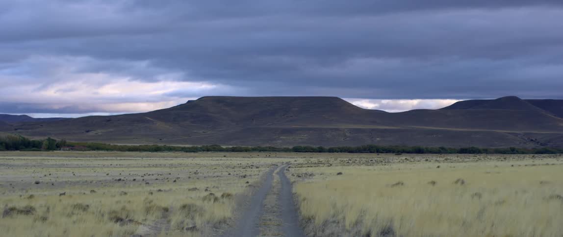 Prairie with mesa mountain and a cloudy sky