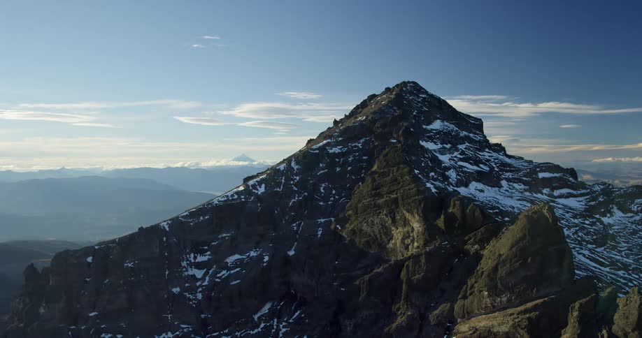 A tall mountain overlooks the valley below