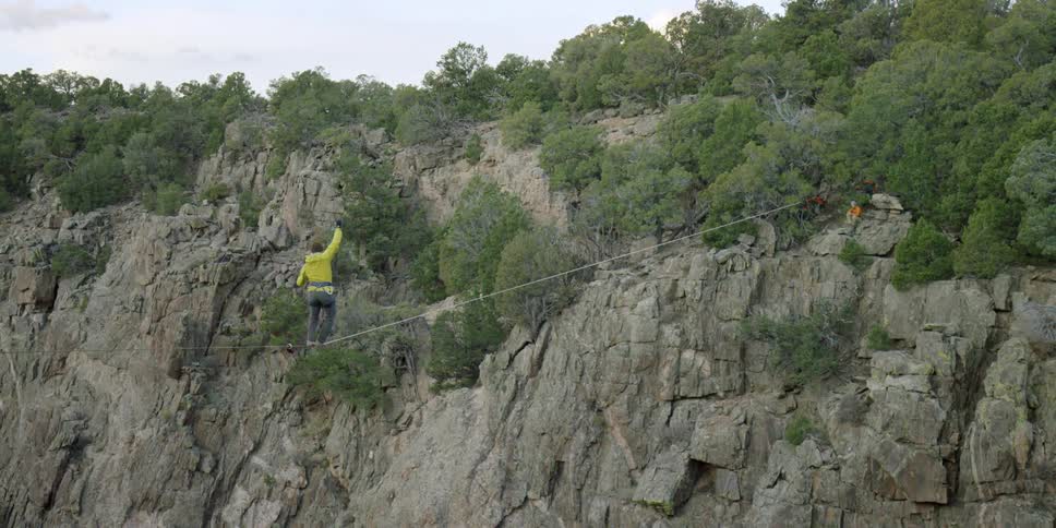 A person is walking over a tightrope