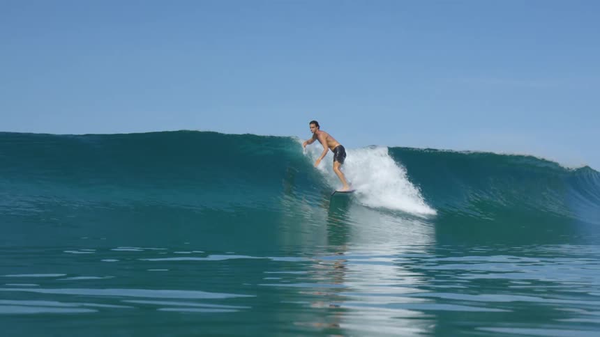 A man is surfing in the ocean