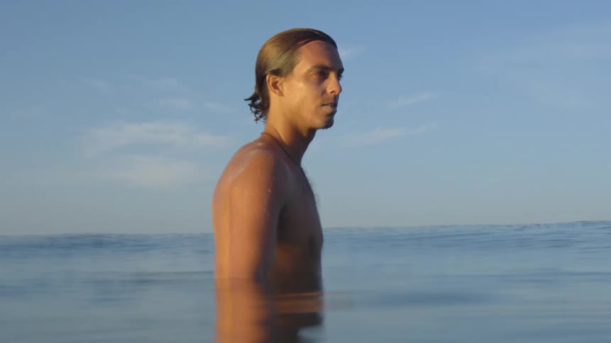 A man is swimming in the ocean