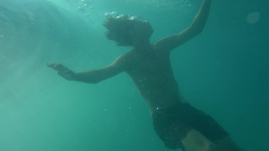 A man is swimming in the ocean
