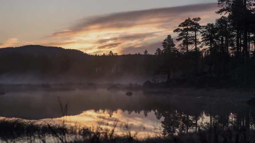 Fog swirling over a remote lake in Finnish Lapland