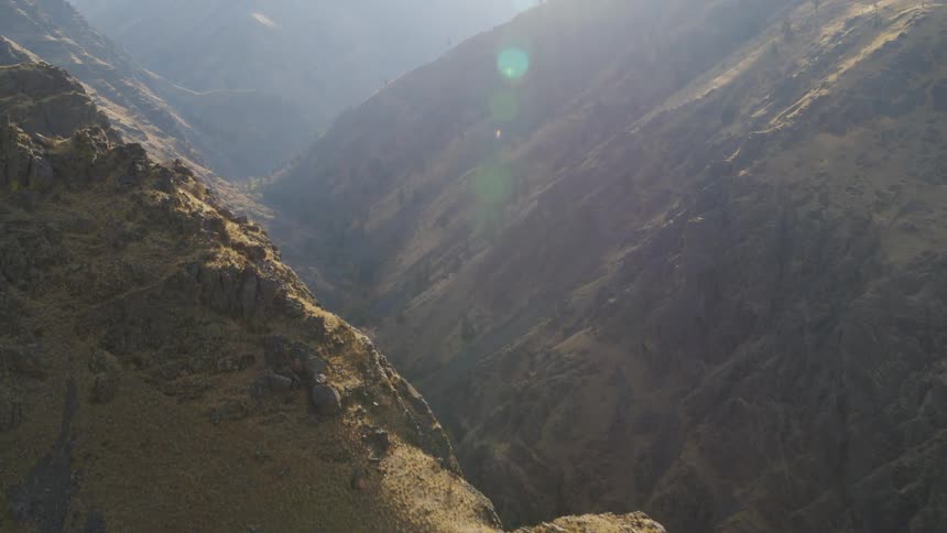 Flying along the ridge above a deep mountain valley