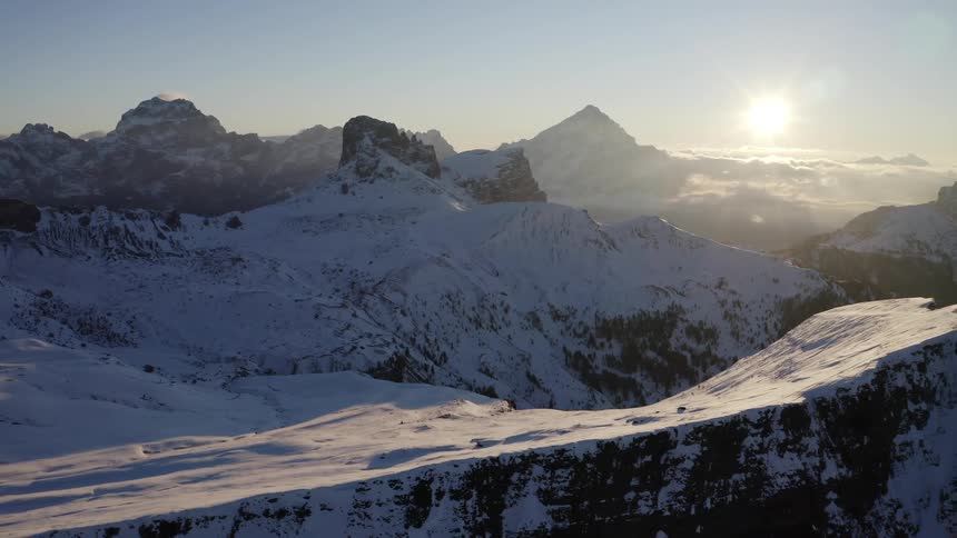 Aerial view of snow capped mountains at sunset