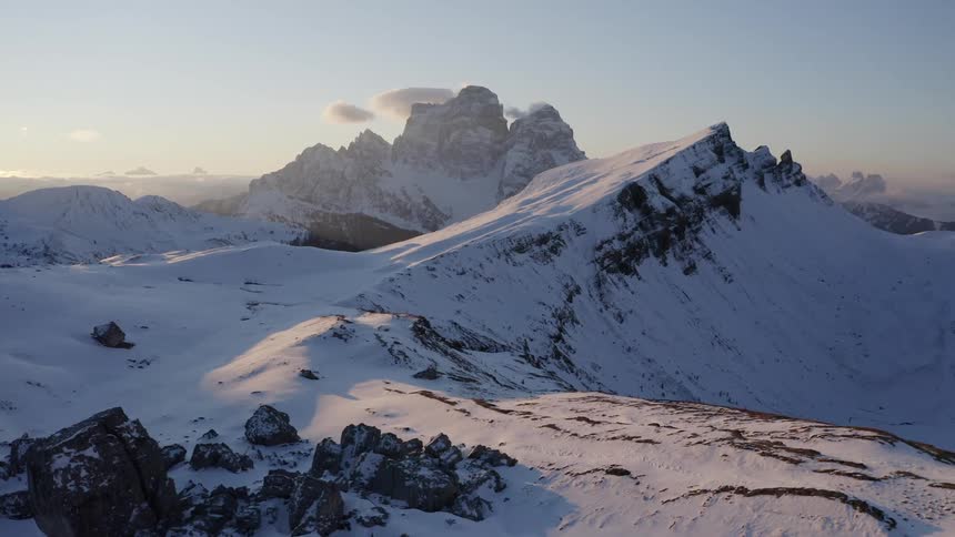 An aerial view of mountains with snow