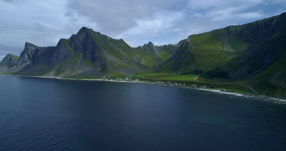 Small coastal town in the shore of a mountain range