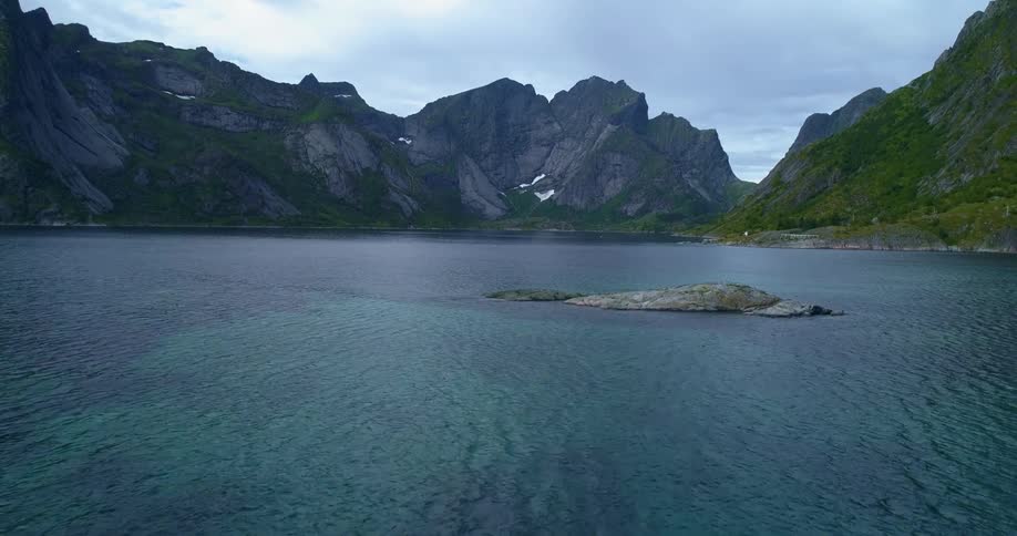 Mountains and island lake on a cloudy day