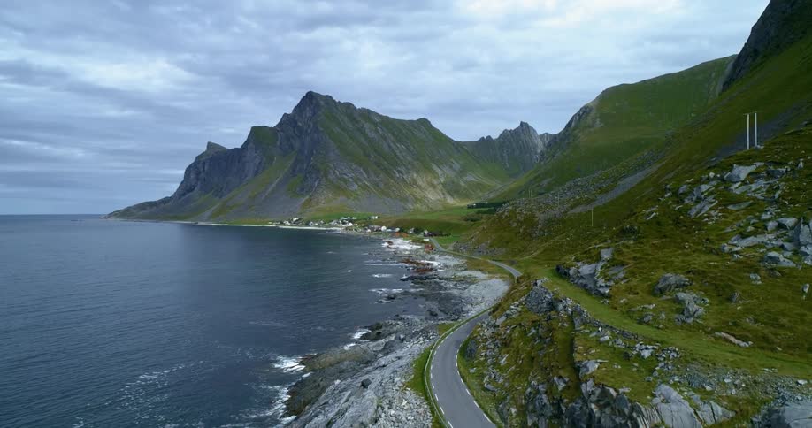 Small town at the end of winding road with the ocean on one side and moutains and cliffs on the other