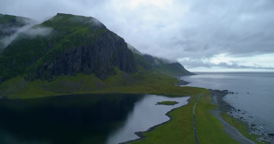 An aerial view of a lake and cliffs on the shore