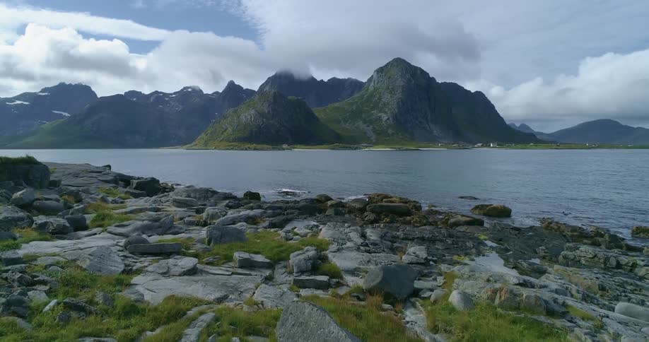 A landscape view of a waterway with mountains on the shore