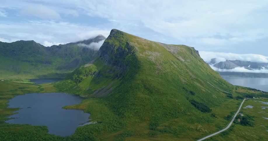 Road passes by green mountains and lakes