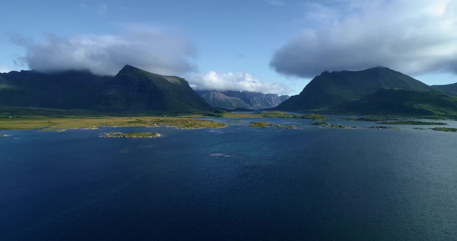 Aerial view of clouds floating on top of mountains in the coast