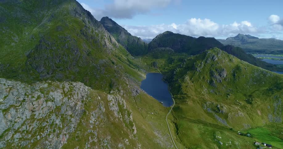 A small lake sits in the valley of a canyon