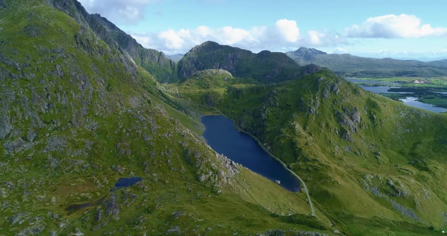 Green rocky mountains with lakes and rivers on a bright sunny day