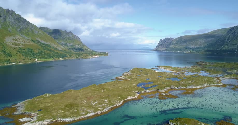 A landscape view of mountains on the shoreline and a lake