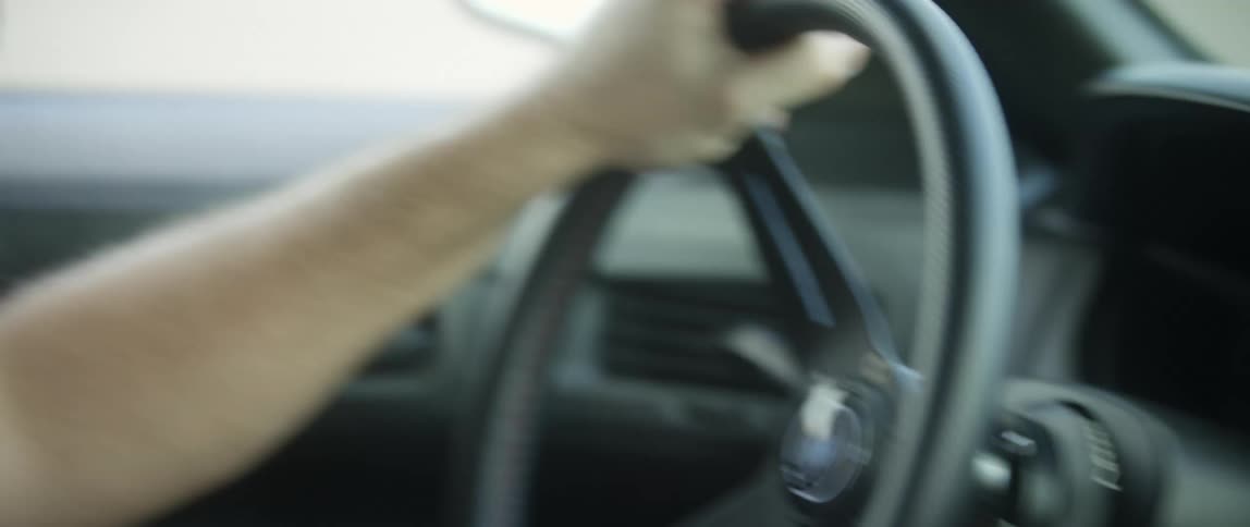 A car shakes while driving at high speed as the male driver struggles to maintain control