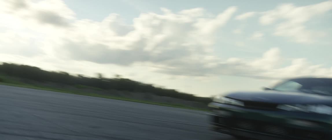 Sports car leaves a trail of smoke drifting on a race track
