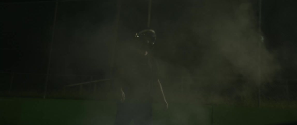 A man jumps out of his car to check on smoke rising from the hood