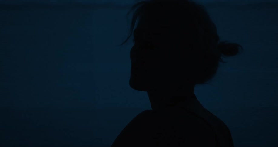 Female model posing in front of a screen that keeps changing colours