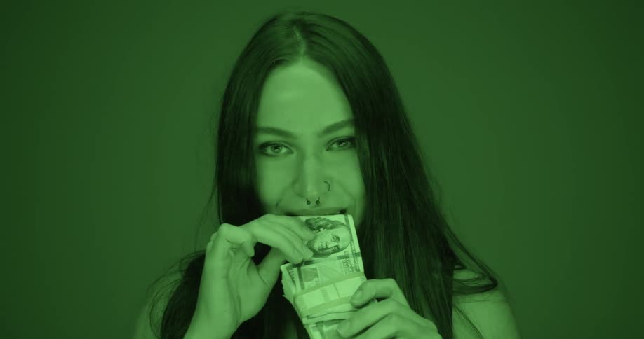 A woman bites a bill from a stack of one hundred dollar bills