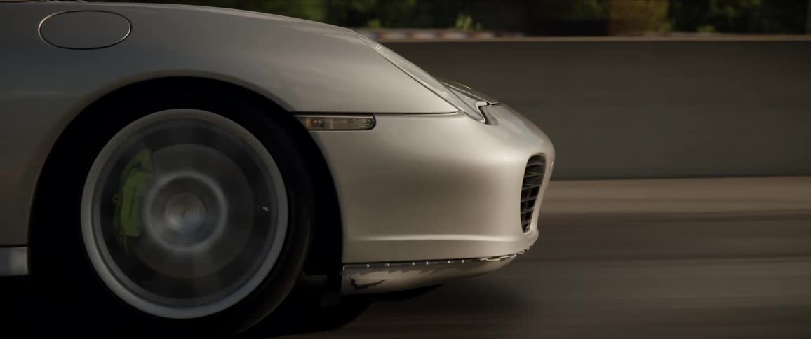 A person drives a sports car down a street