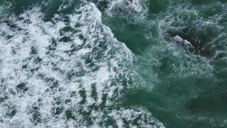 Ocean waves roll in with the tide