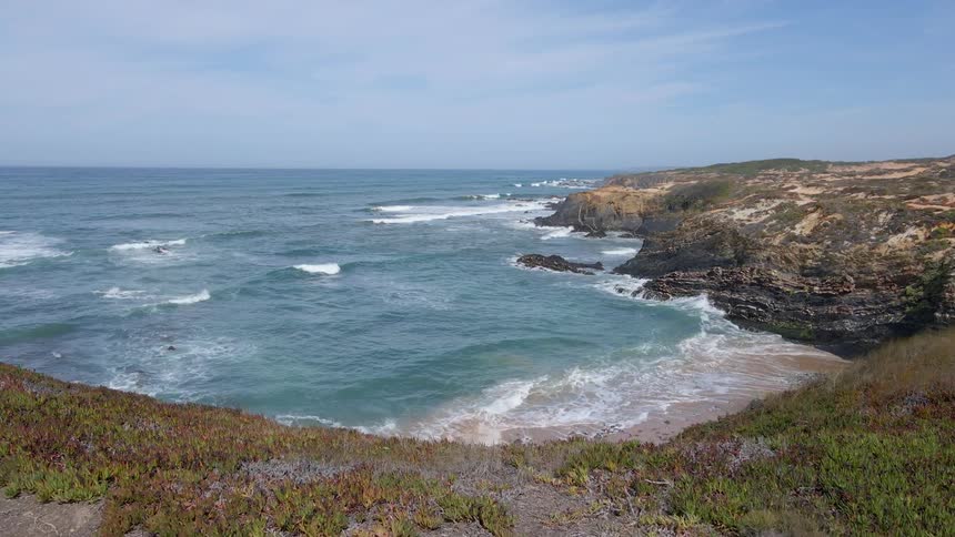 Aerial view of ocean waves crashing against the cliffs