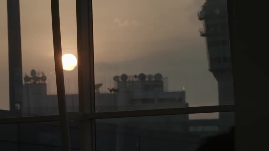 The sun is setting over some buildings