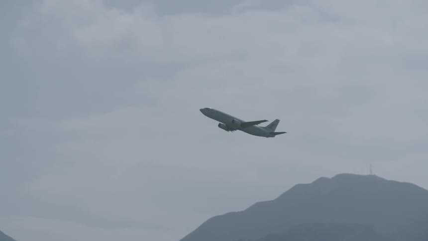 A plane is flying over a mountain range