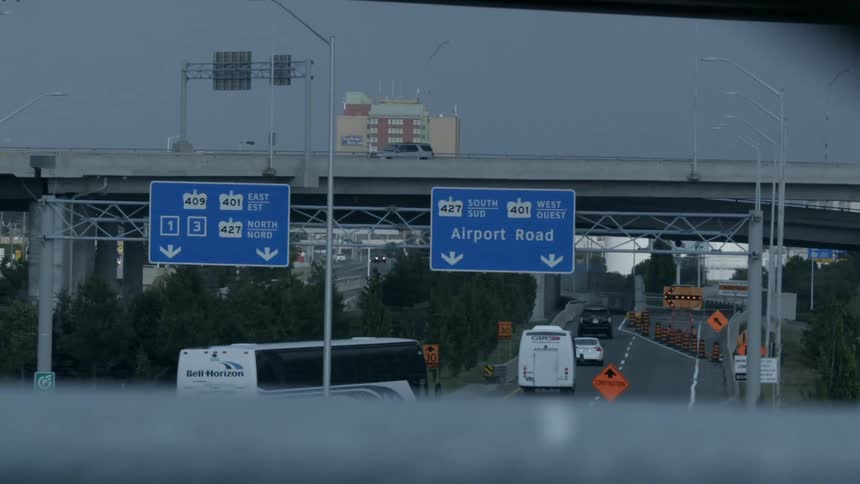 Airport road signs above a freeway