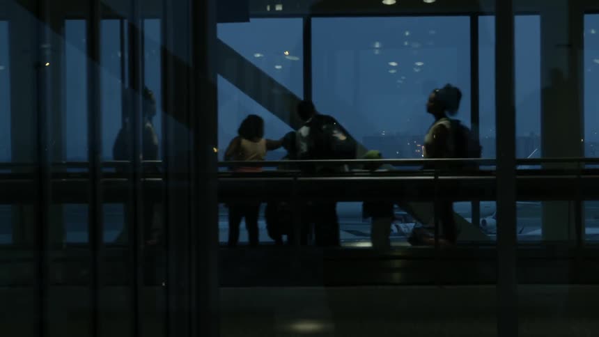 People are riding an escalator inside of a building