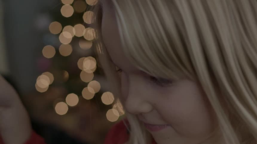 Close up of a child lifting a present