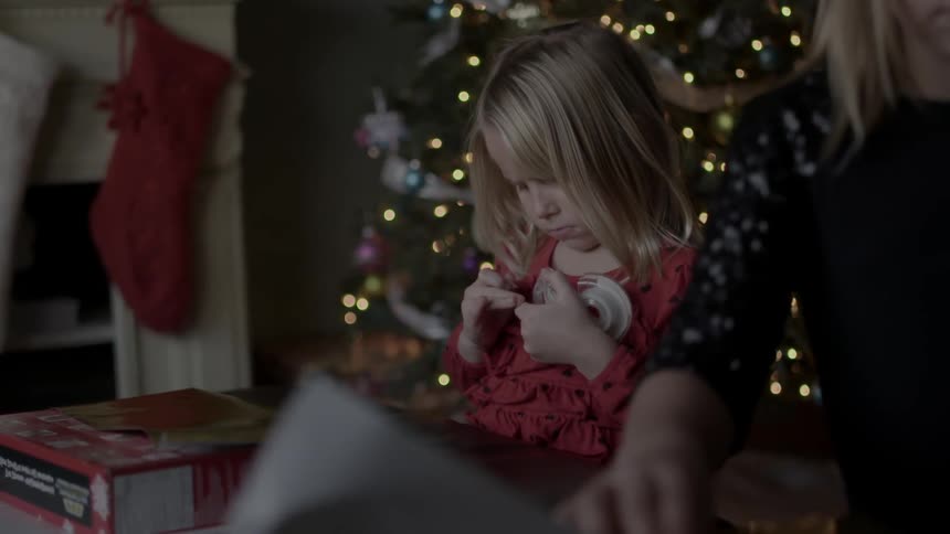 Little girls wrapping christmas presents