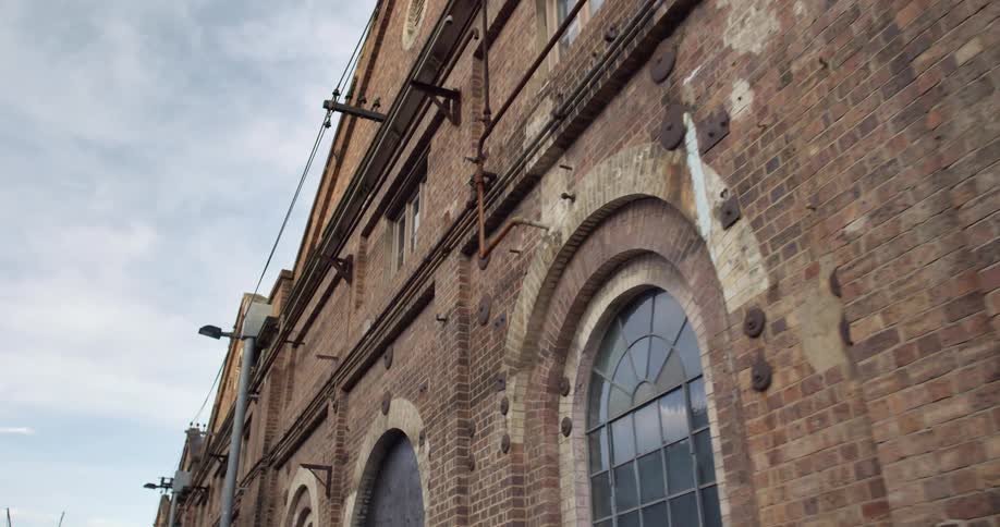 Red brick wall and windows on an old warehouse