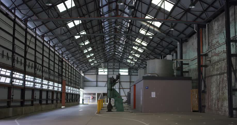 Machinery under the tall roof of a big warehouse
