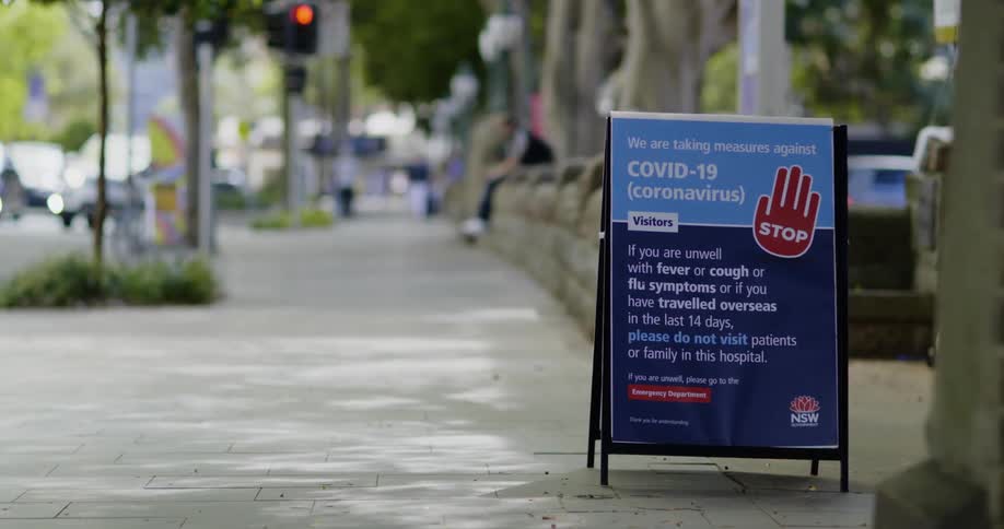 A sign outside a business describes an action plan for dealing with coronavirus