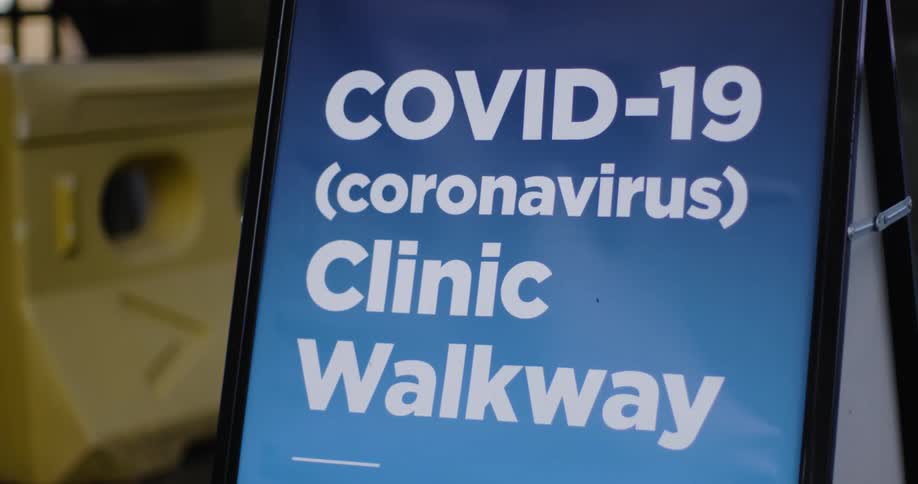 Street sign on an easel for a clinic performing covid 19 tests