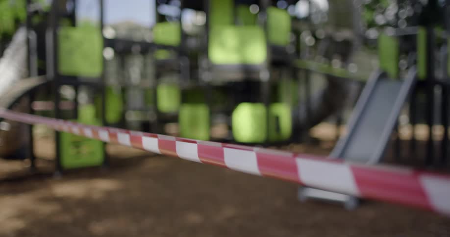 Playground equipment is marked from entry with red and white checked tape