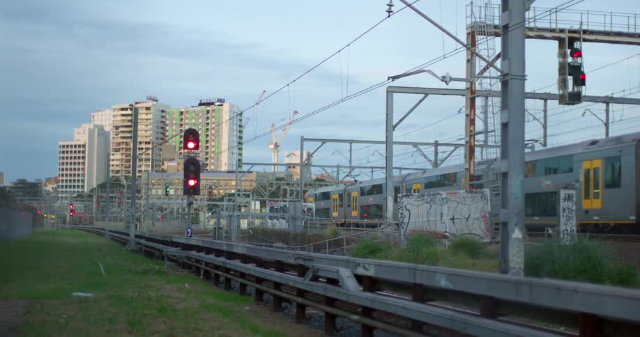 Electric passenger train entering the city from the outskirts