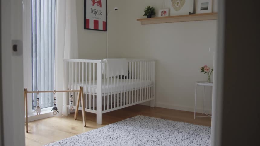 Babys room with a white baby crib and other white furniture