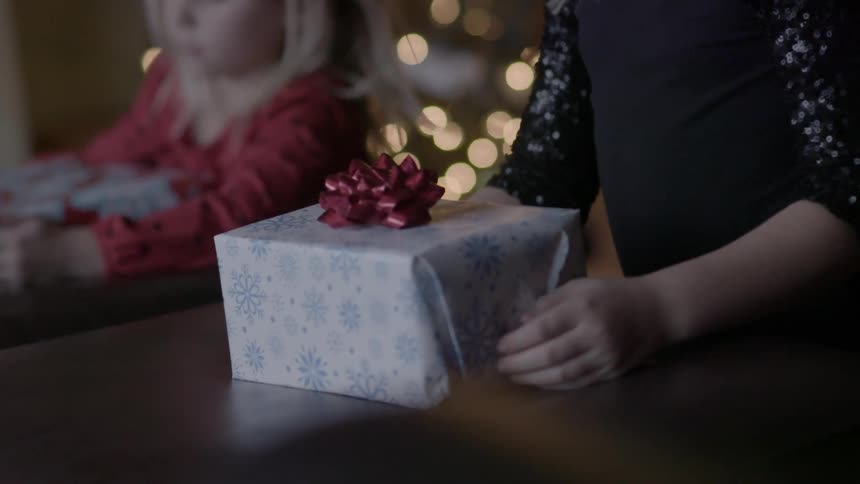 Two children are wrapping presents
