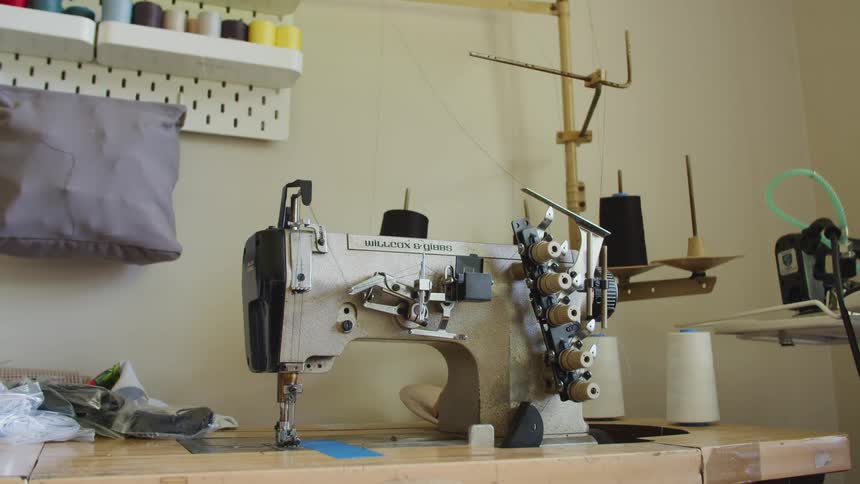 Industrial overlock sewing machine inside a room at home