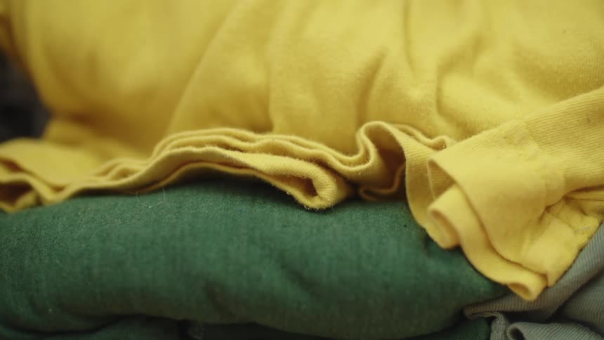 Close up of rolls of colorful cotton clothes piled onto each other
