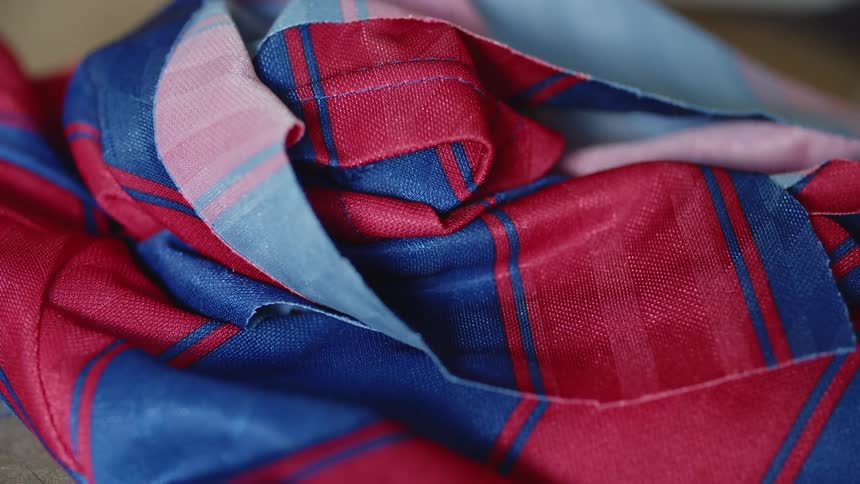 A red and blue fabric sits crumpled on a table