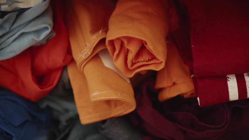 Rolls of colorful cotton clothes piled up in a room