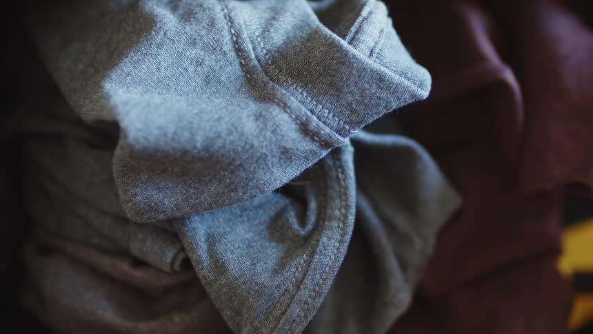 Gray and purple colored shirts folded